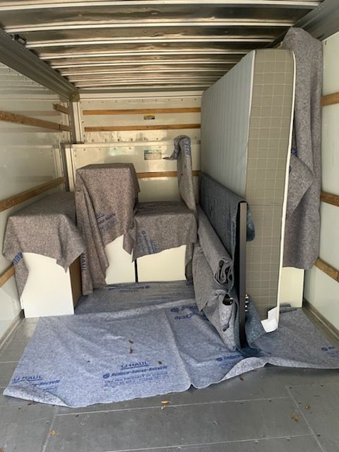 The inside of a moving truck covered in blankets