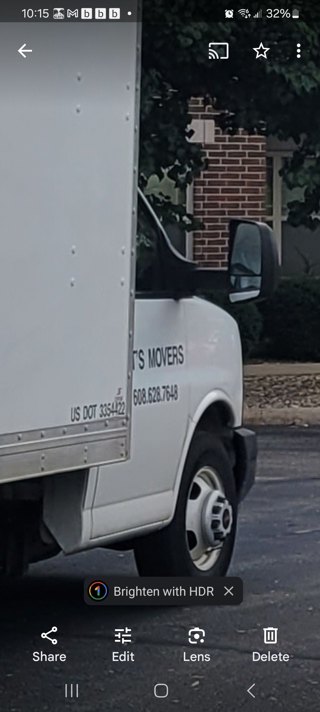 A white van is parked on the side of the road.