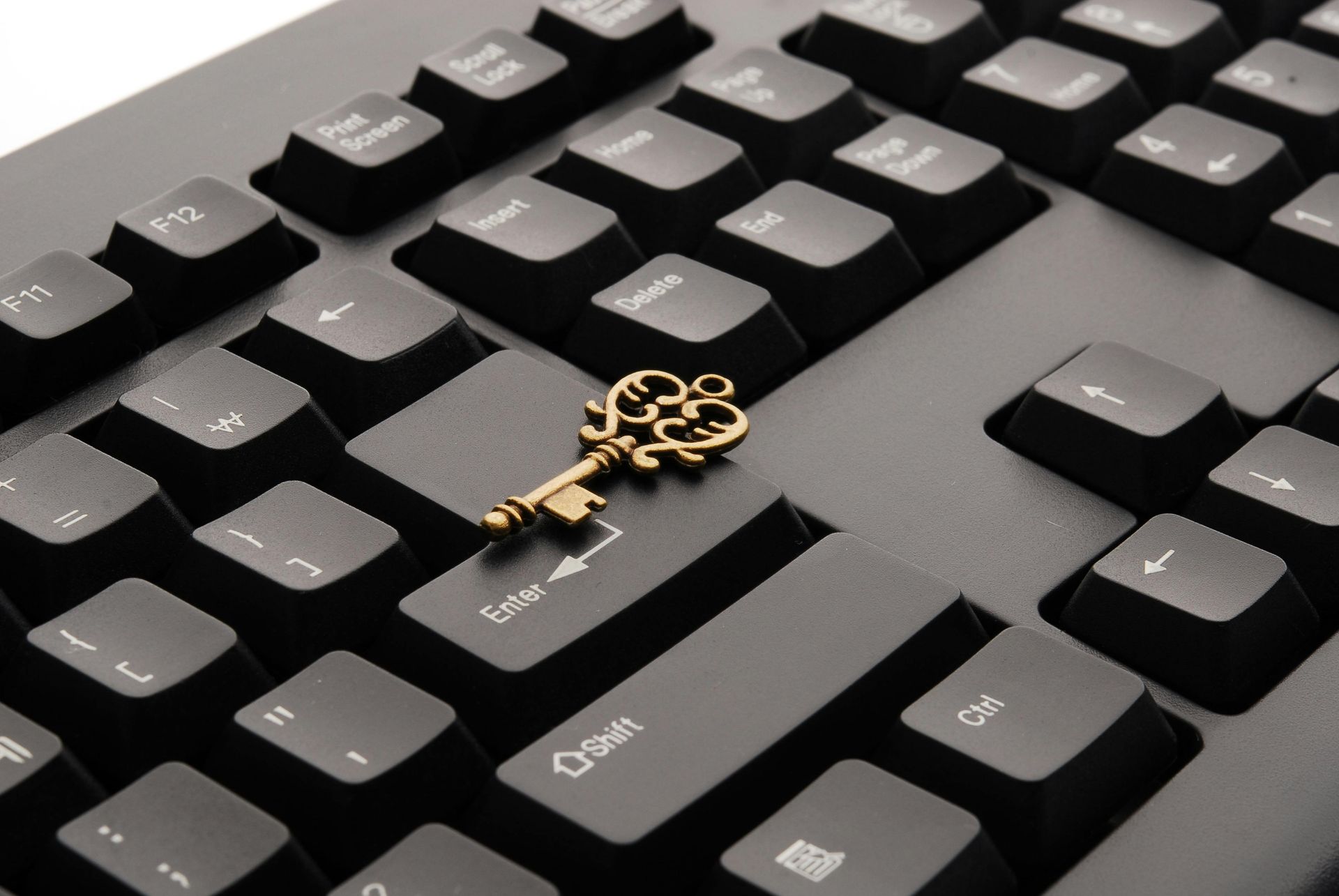 An image of a keyboard with a key sitting on top, signifying security.