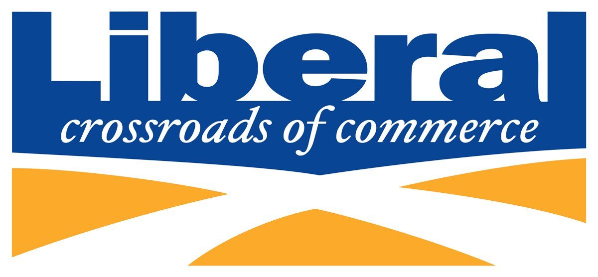 The liberal crossroads of commerce logo is blue and yellow.