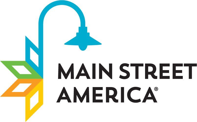 A logo for main street america with a street light and leaves.
