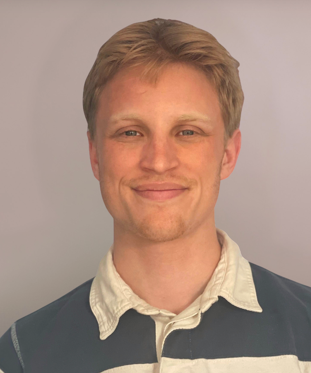 A headshot photo of a man wearing a button down shirt 