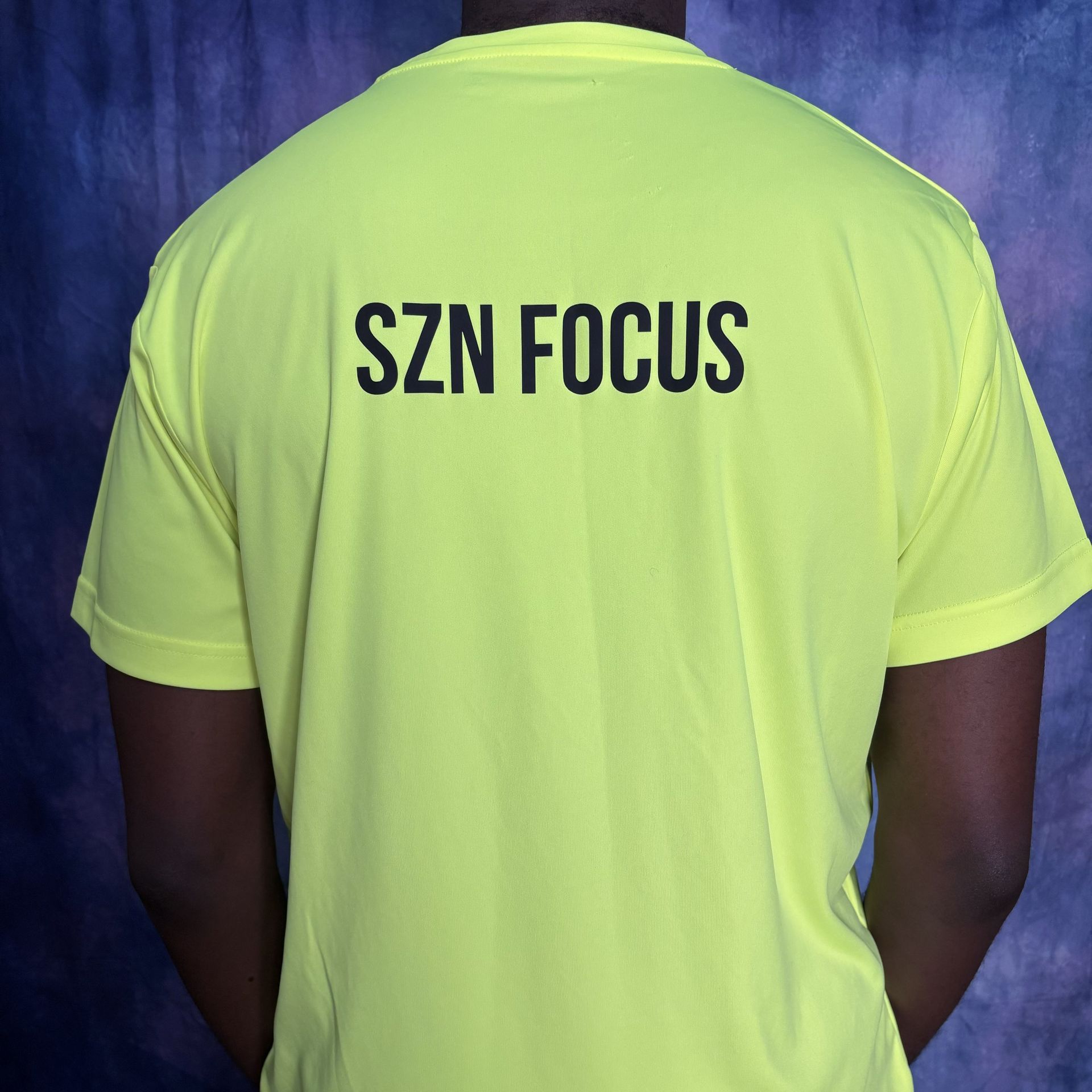 Bright yellow t-shirt with a black lightbulb design containing a target symbol.