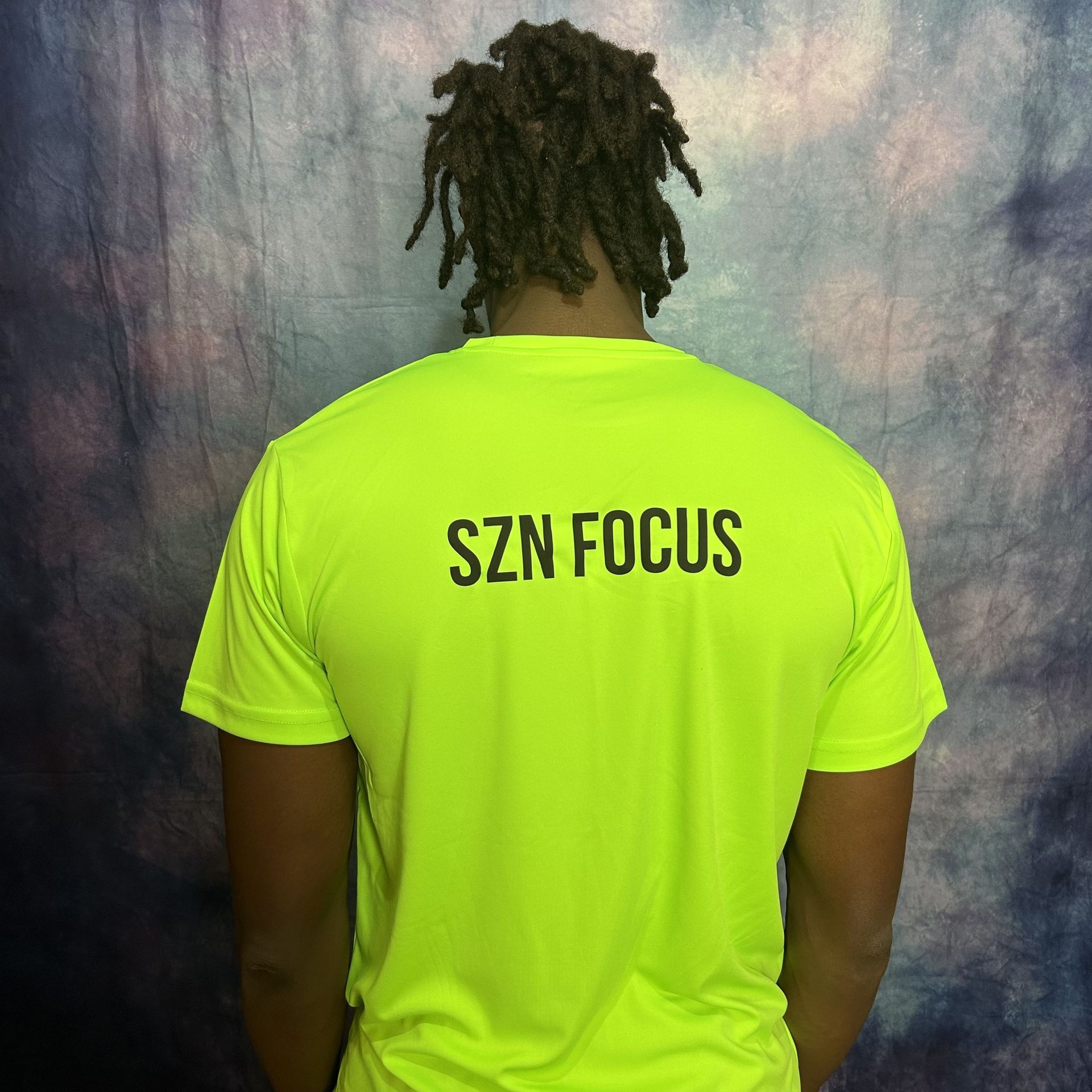 Bright yellow t-shirt with a black lightbulb design, featuring a target in the center.