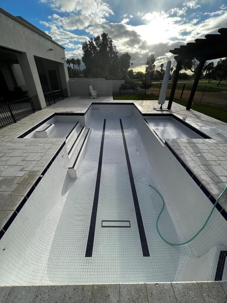 An empty swimming pool with a hose attached to it.