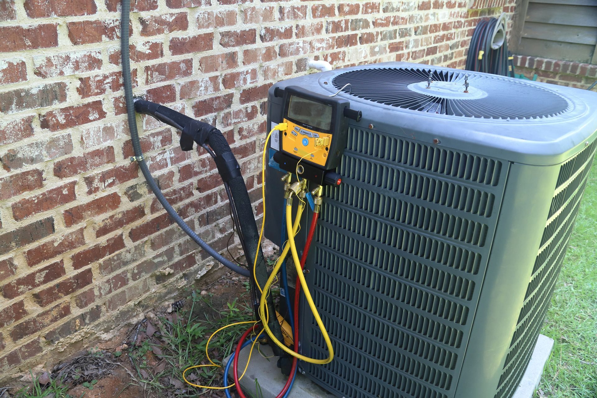 Gauges on an air conditioning compressor checked by a local air conditioning contractor ensuring efficiency