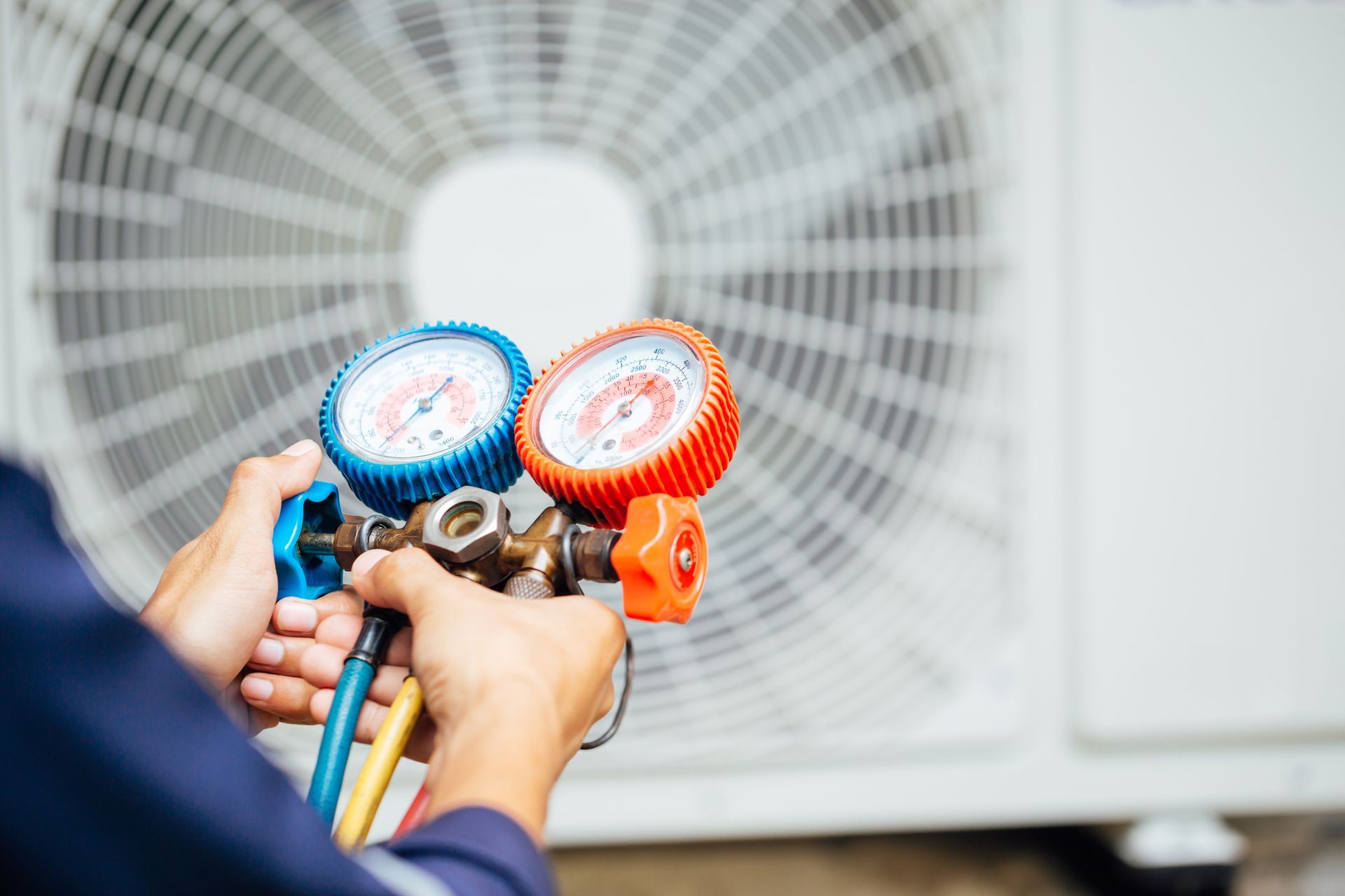 Air conditioning technician, part of a local air conditioning contractor team, preparing to install new unit