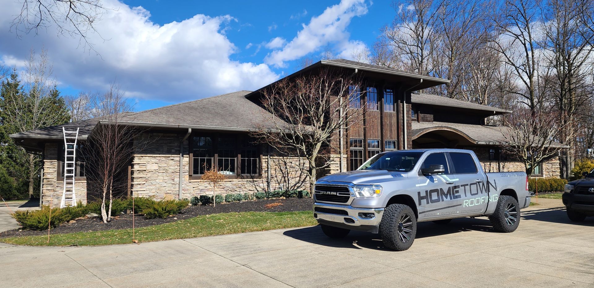 Our vehicle outside a home roofing project 