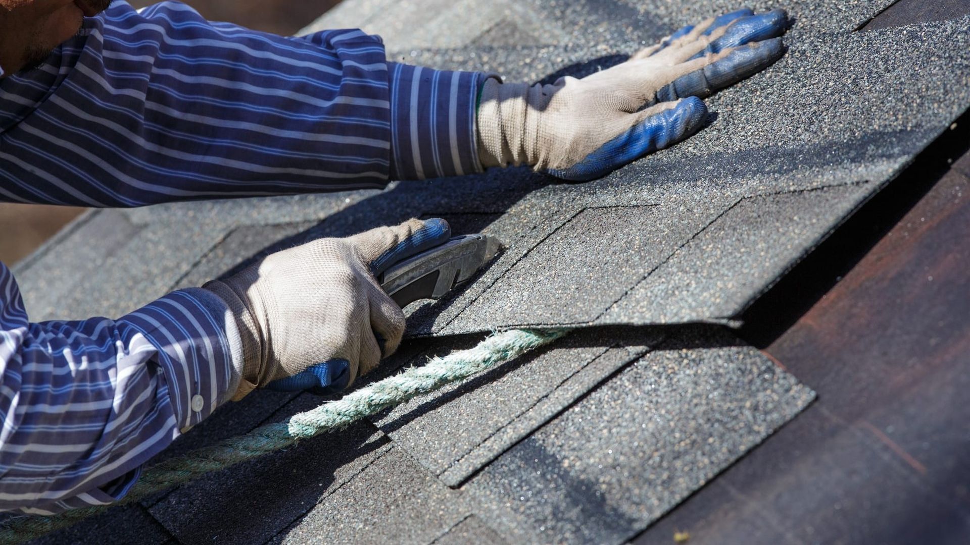 Man repairing a roof in North Canton