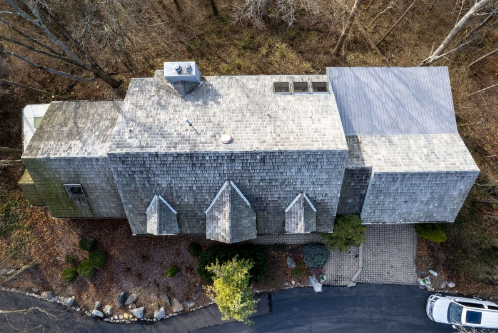 Home with worn real shake roofing