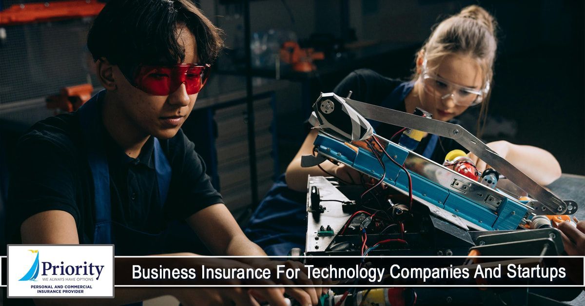 A man and a woman are working on a robot in a garage.