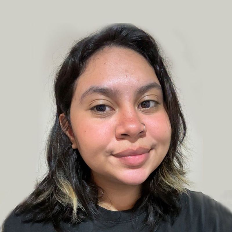 A woman in a black shirt is smiling for the camera.