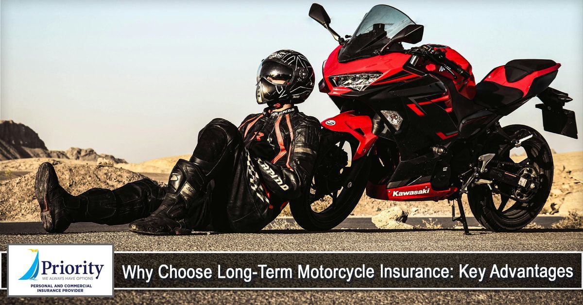 A man is sitting next to a red motorcycle on the side of the road.