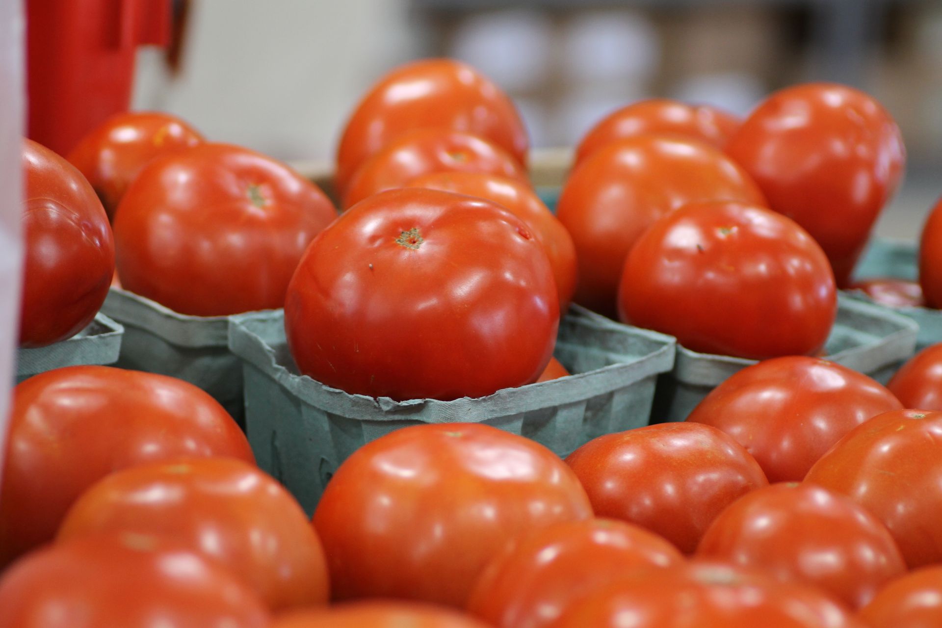 A bunch of tomatoes in baskets on a table