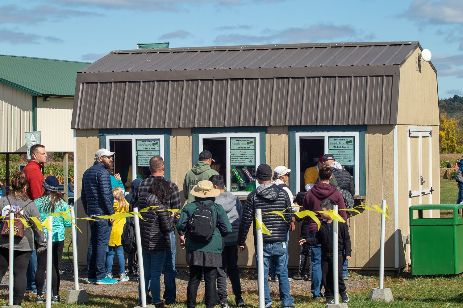 A group of people are standing in front of a shed.