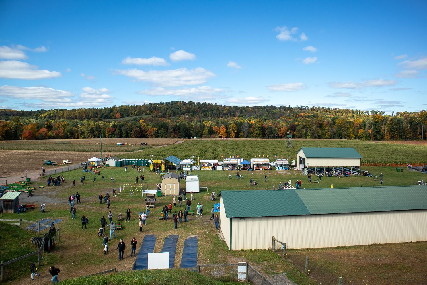An aerial view of a field with a lot of people and buildings.