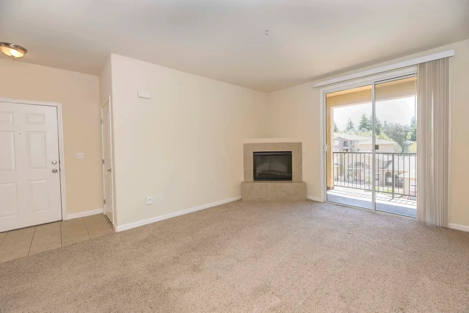 Spacious apartment interior with carpet and fireplace