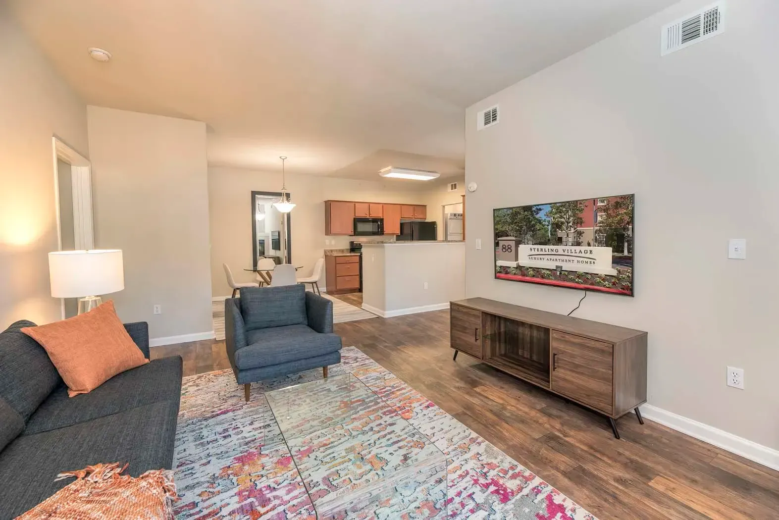 Modern living room with a sofa and a flat screen TV in an apartment.