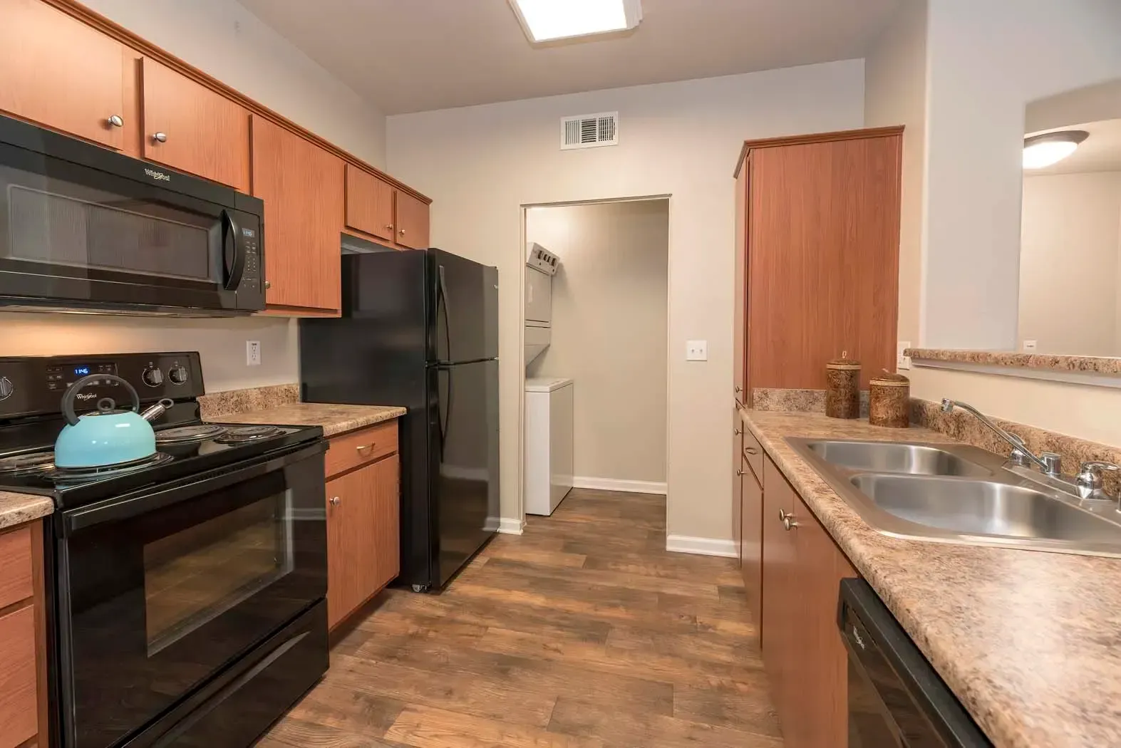 Modern kitchen with black appliances and wooden cabinets
