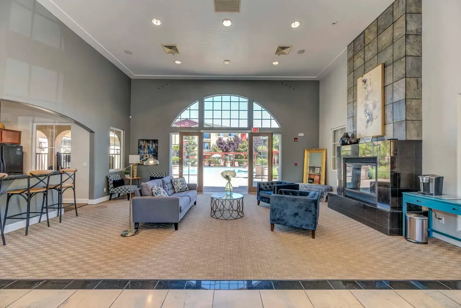 Inviting lobby area with seating and large windows overlooking the pool.