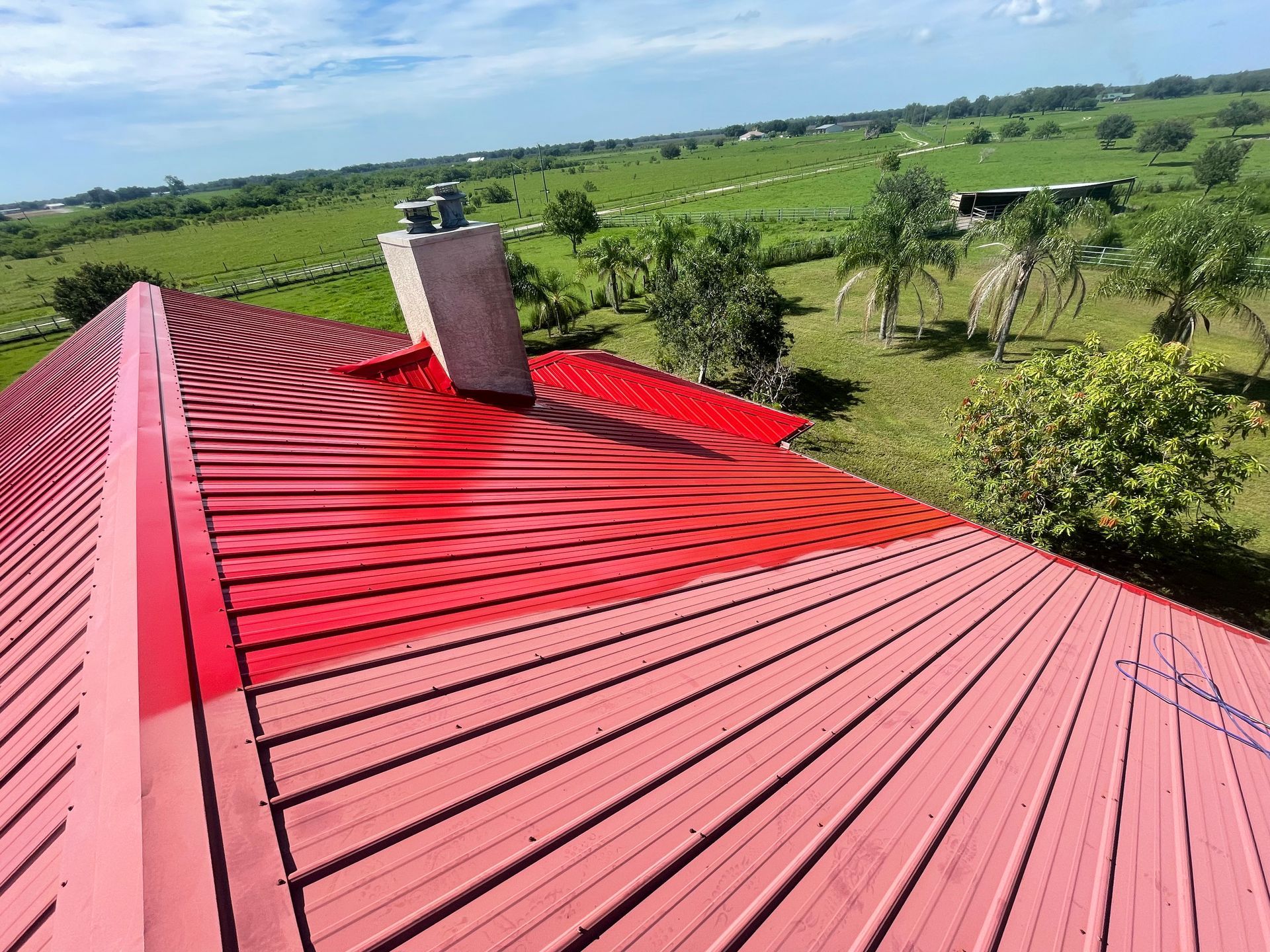 A red roof with a chimney on top of it.