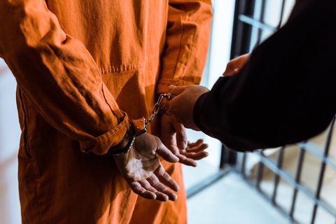 Hands Locked in Handcuffs — Munice, IN — Reliable Bail Bonds