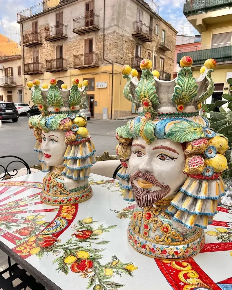 Colorful ceramic decorations displayed along a traditional street in Caltagirone
