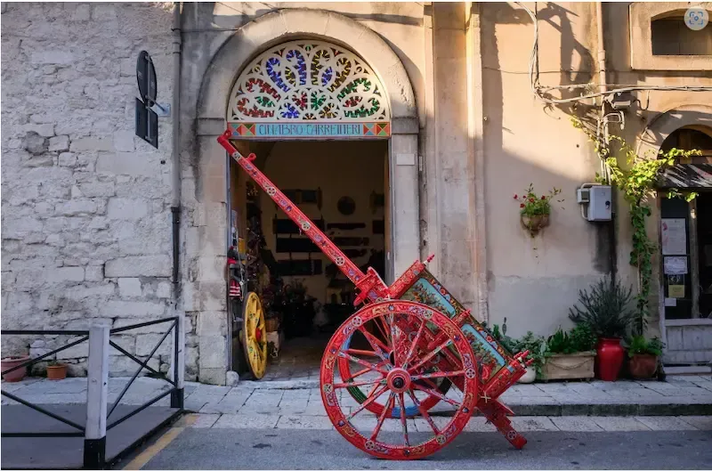 Traditional Sicilian cart workshop with hand‑painted wooden decorations