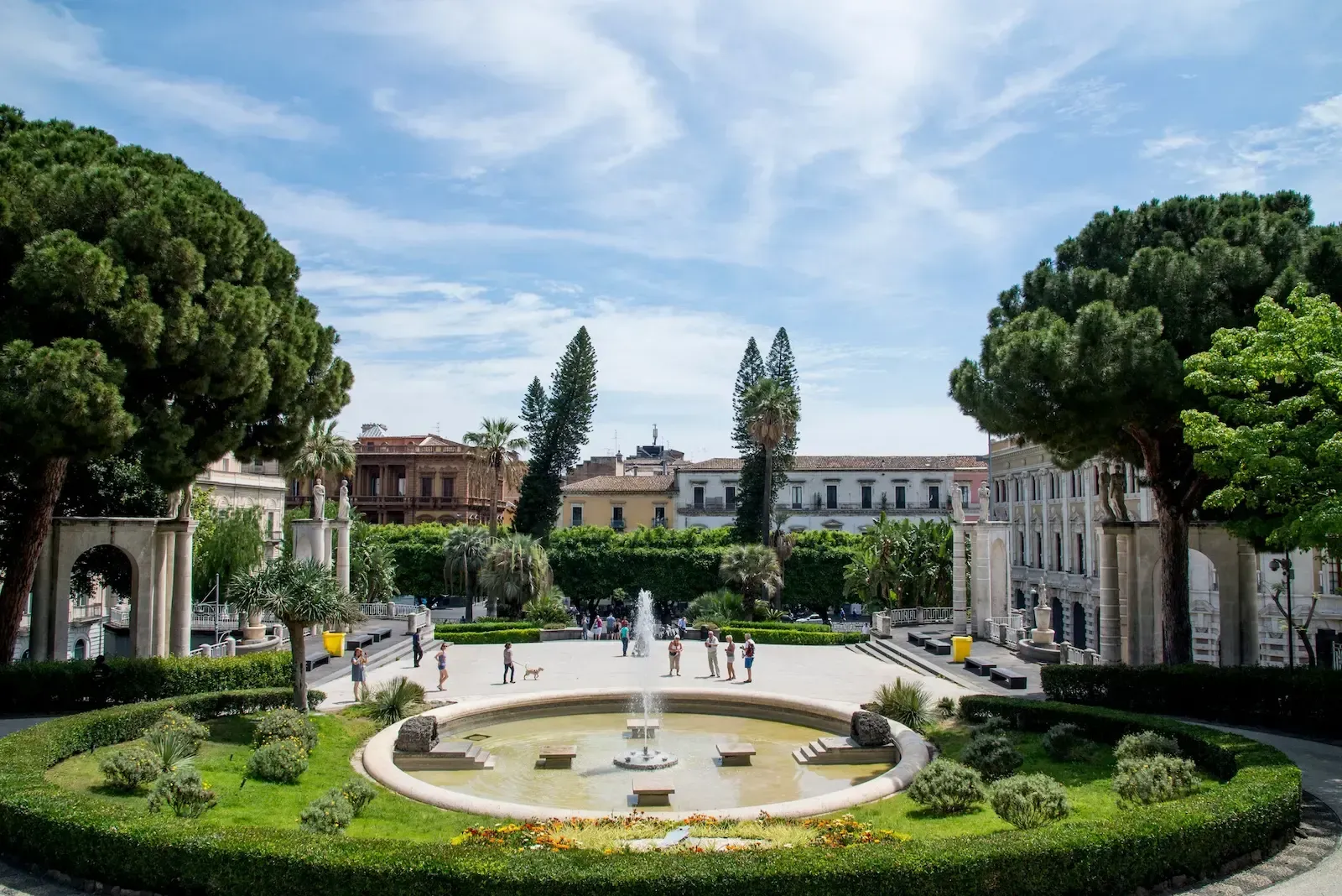 Pathways and gardens inside Giardino Ibleo in Ragusa with visitors walking