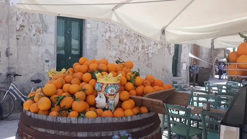 Fresh oranges displayed in a traditional Sicilian market in Marzamemi
