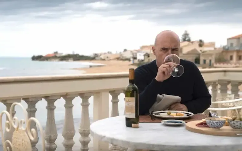 Outdoor dining scene on the Sicilian coast, inspired by Inspector Montalbano locations