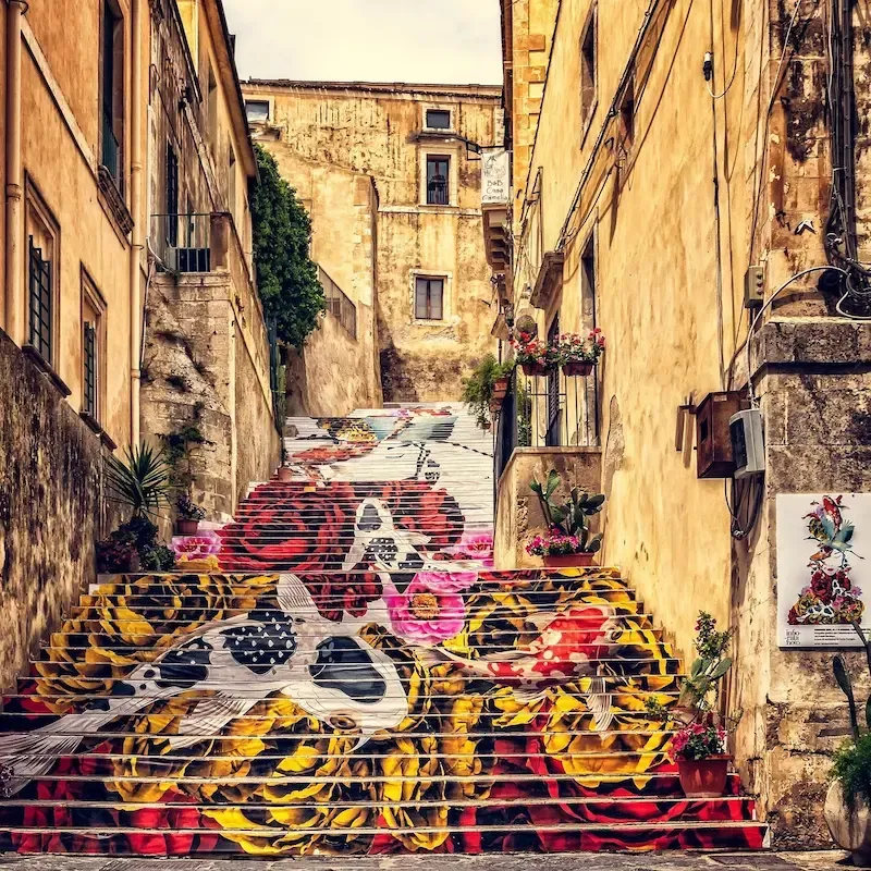 Historic street in Noto with Baroque buildings and warm golden stone