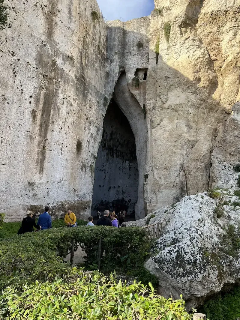 Ancient stone archway inside the Archaeological Park of Siracusa