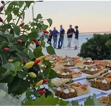 Pozzallo seaside view with people enjoying the waterfront during a Sicilian weekend event