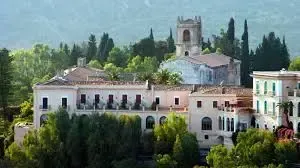 Historic San Domenico Palace in Taormina surrounded by gardens and Mediterranean scenery