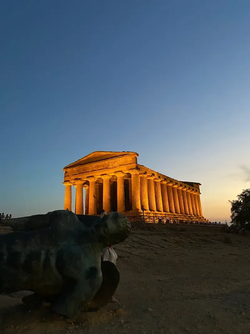 Remains of a Telamon giant statue lying among the ruins in the Valley of the Temples