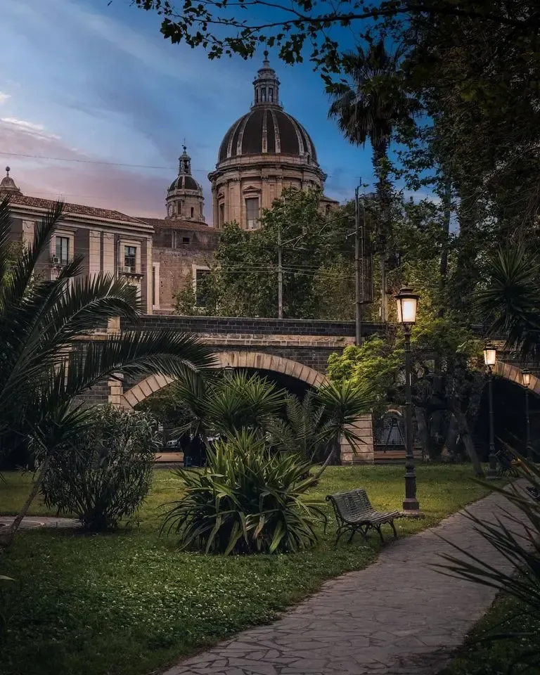 Historic domed building in Catania at dusk near the Archi della Marina