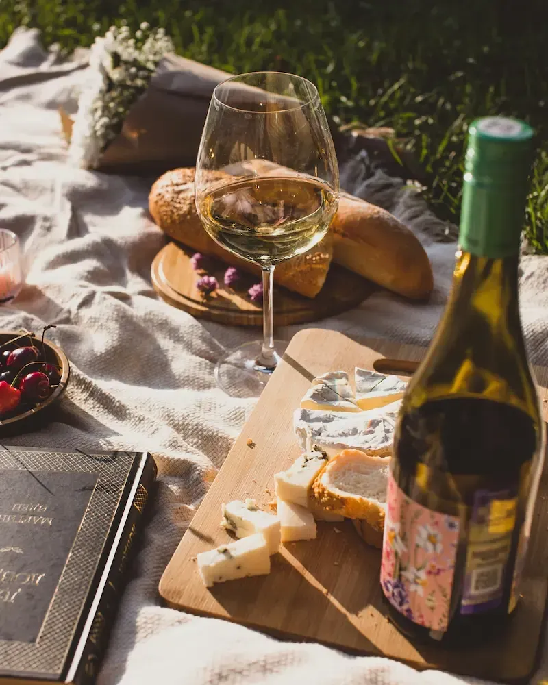 Glass of Sicilian white wine served outdoors during a wine tasting experience.