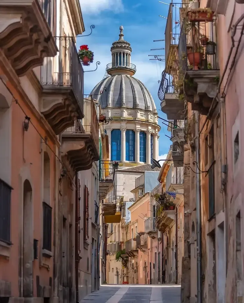 View of Ragusa Ibla with the dome of San Giorgio Cathedral between narrow streets