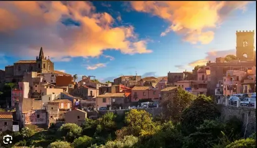 Forza d’Agrò village at sunset with warm light over historic Sicilian buildings