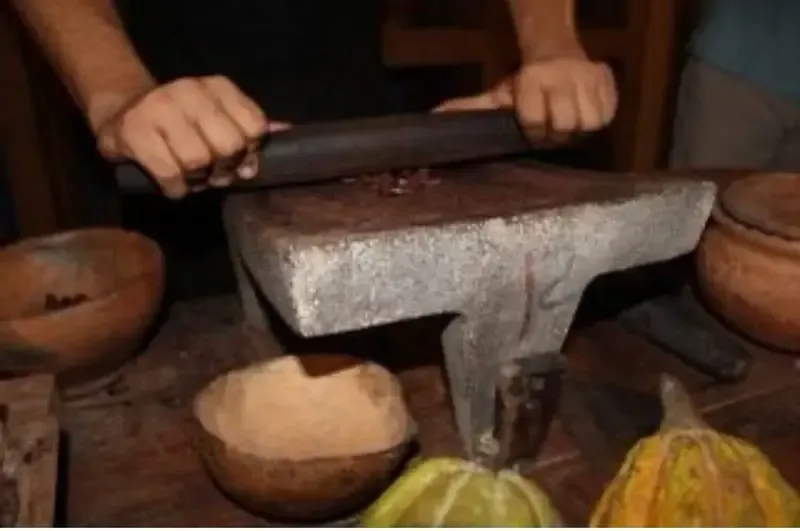 Traditional Sicilian chocolate being crafted by hand on a stone surface in Modica