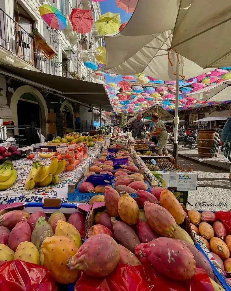 Traditional Sicilian market with hanging decorations and local food stalls