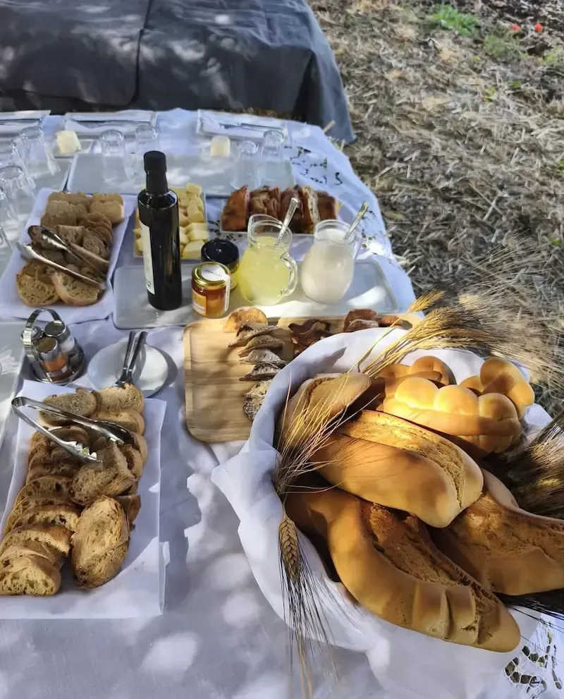 Selection of traditional Sicilian food products including bread, olive oil, cheese and wine