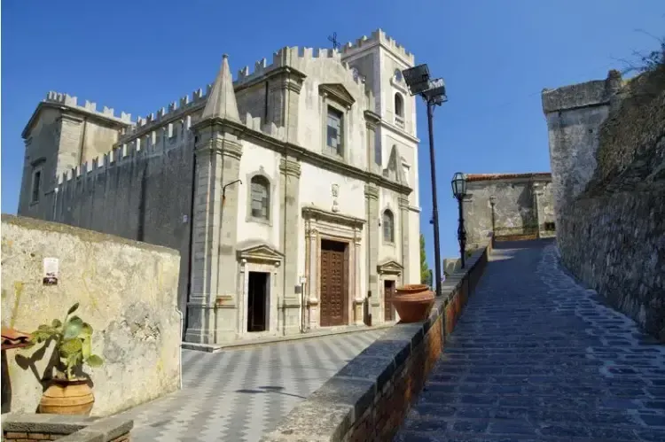 Historic stone church and narrow street in Savoca, featured in The Godfather.