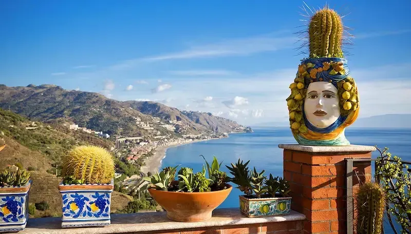 Scenic view of Taormina with decorative Sicilian pottery overlooking the coastline