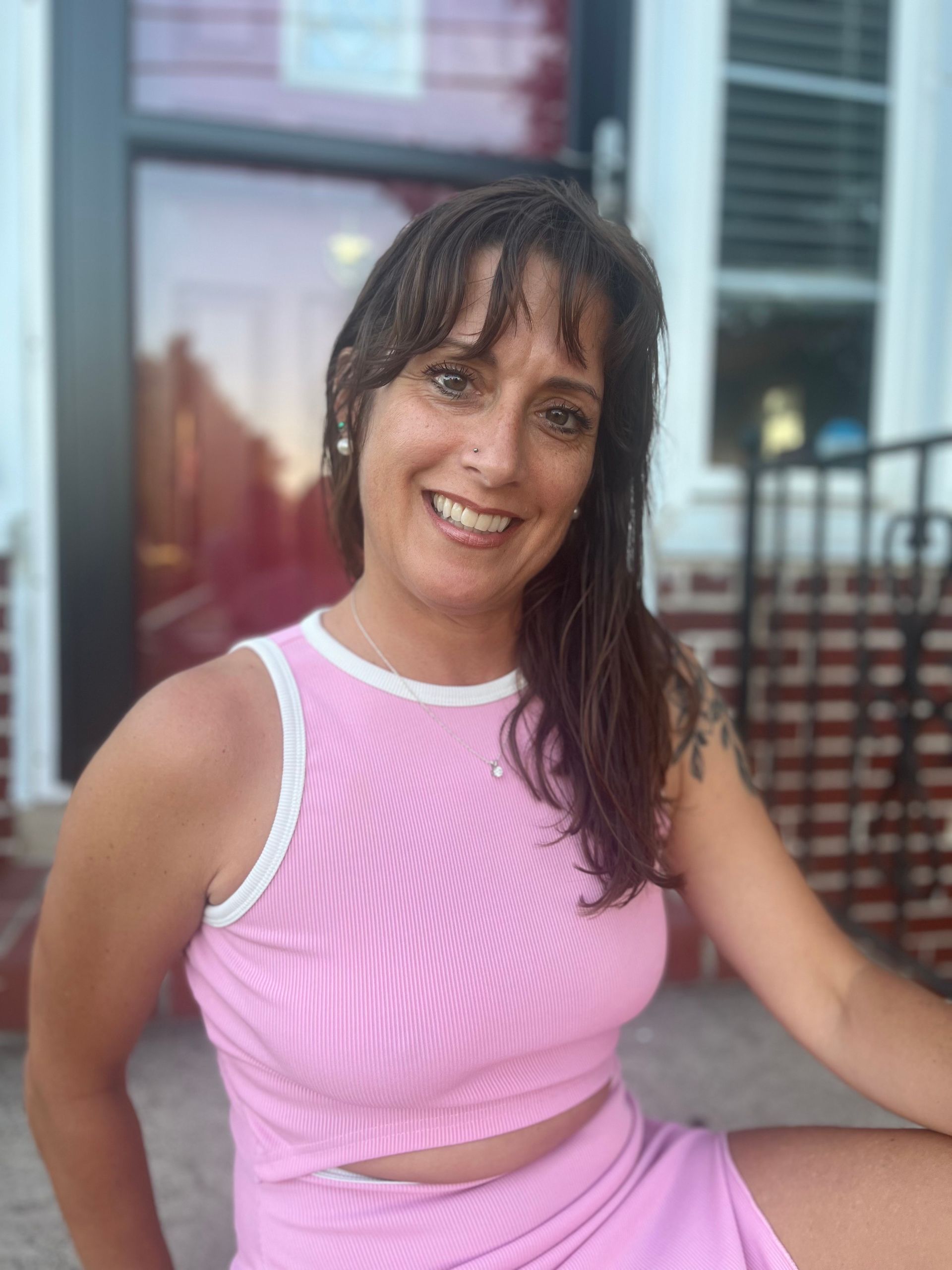 A woman is doing a split on a wooden floor.