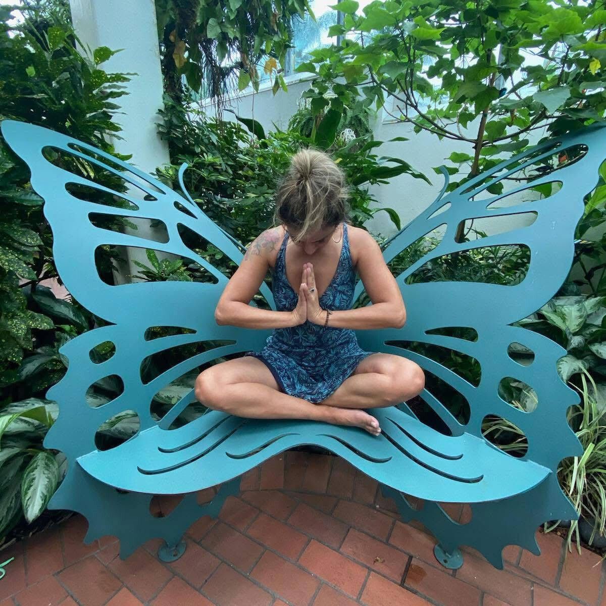 A woman is doing a split on a wooden floor.