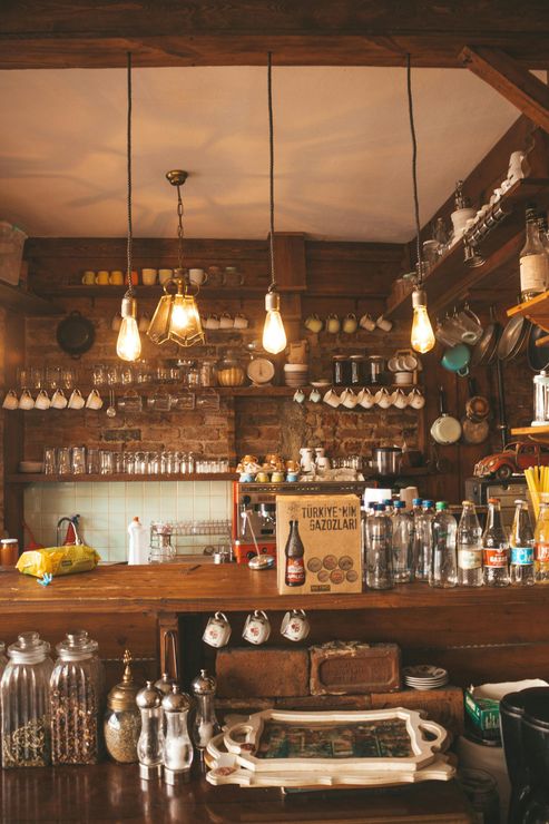 A bar with a lot of bottles and jars on it.