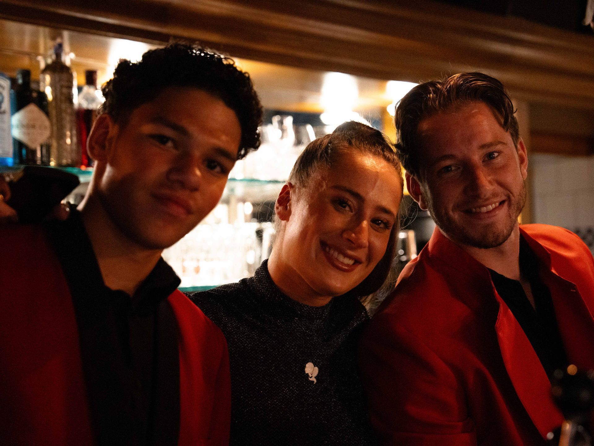 Drie mensen poseren voor een foto in een bar.  bij Linke Loetje