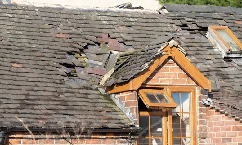 A house with a broken roof and a window